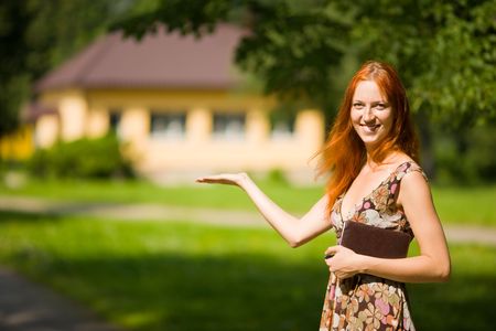 Real Estate Agent smiles near new house for saleの写真素材