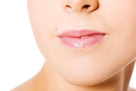 Young woman's Lips and nose close up isolated on whiteの写真素材