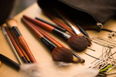 Hairpins and Brushes for makeup on table selective focusの写真素材
