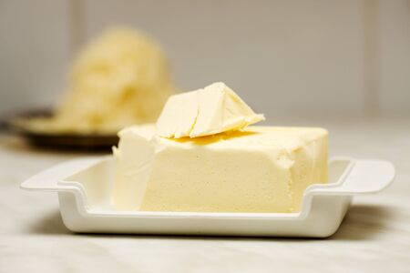 Macro shot of butter on plate on kitchen tableの写真素材