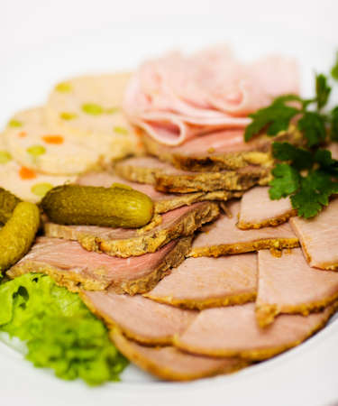 Meat and bloated sausage Slices on plate macro shotの写真素材