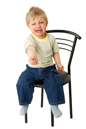 Desperatly asking Crying boy sitting isolated on whiteの写真素材