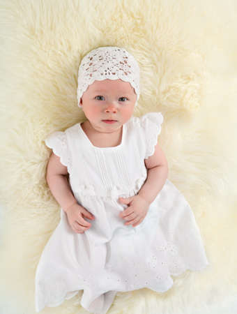 Baby girl in the age of five months lying downの写真素材