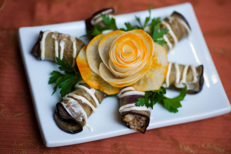 baked aubergine rolls on plate in restaurantの写真素材