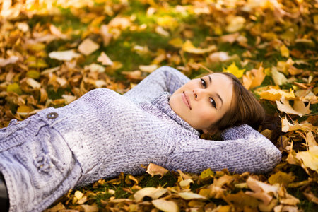 Happy smiling young woman portrait autumn outdoorsの写真素材