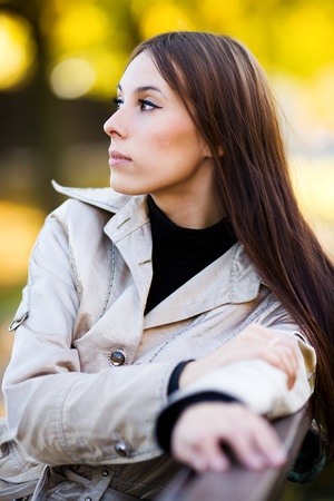 Pensive young woman portrait autumn outdoorsの写真素材