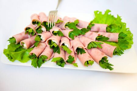 ham rolls on plate with lettuce macro shotの写真素材