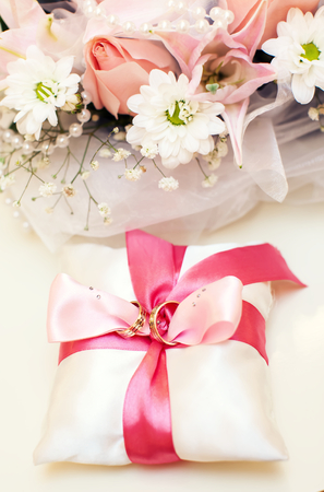 Two Golden Wedding Rings on pillowの写真素材