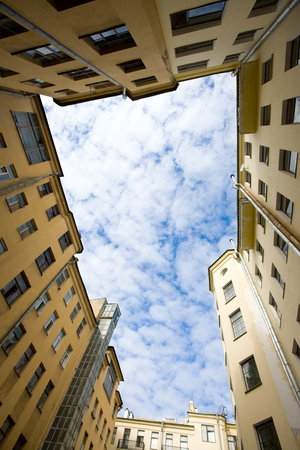 Closed courtyard and sky The bottom view upwardsの写真素材