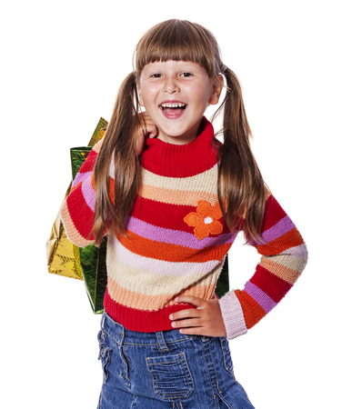 Smiling six years Girl holding presents bags isolatedの写真素材