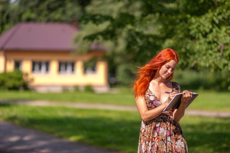 Real Estate Agent smiles near new house for saleの写真素材