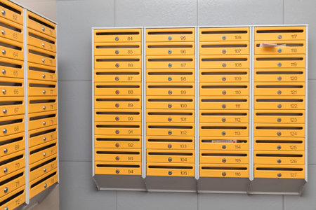 row of gray mailboxes in corridor of apartment building