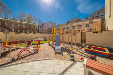 Colorful playground equipment for children in public yard in summerの写真素材