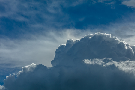 Deep blue bright sky with stormy clouds backgroundの写真素材