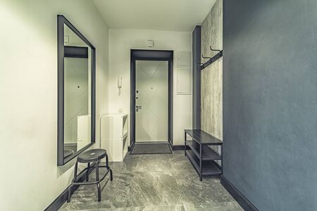Empty residential house entrance with closed wooden doors tiny hallwayの写真素材
