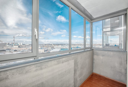 Small old common open balcony interior in high residential apartment building maid of cement
