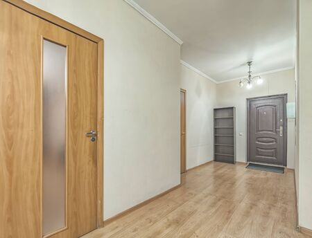 Empty residential house entrance with closed wooden doors tiny hallwayの写真素材