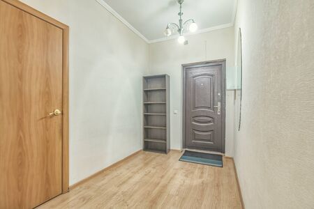 Empty residential house entrance with closed wooden doors tiny hallwayの写真素材