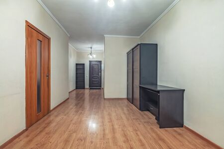 Empty residential house entrance with closed wooden doors tiny hallwayの写真素材