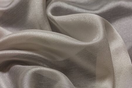 Shiny cloth background with white vial textile multiple curlsの写真素材