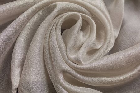 Shiny cloth background with white vial textile multiple curlsの写真素材