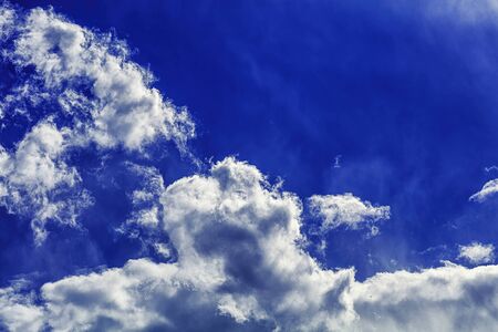 Bright deep blue sky beautiful clouds and fresh air for backgroundの写真素材