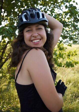 Smiling girl in bicycle helmet outdoor の写真素材