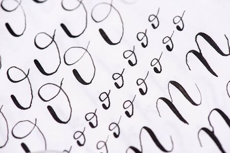 Black ink calligraphy on lined sheet of paper. Learning calligraphy art. Calligraphy recipes .Samples in words.の写真素材