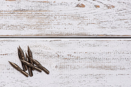 sharp pen for calligraphy, retro style. light wood backgroundの写真素材