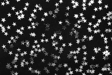 Silver stars on black background. holiday concept. creative layout.の写真素材