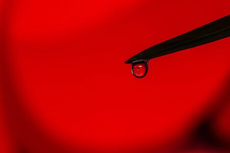 June 14 World Blood Donor Day. Heart in a Water drop - background. Giving blood saves live. Blood Donation concept. Give, charity. の写真素材