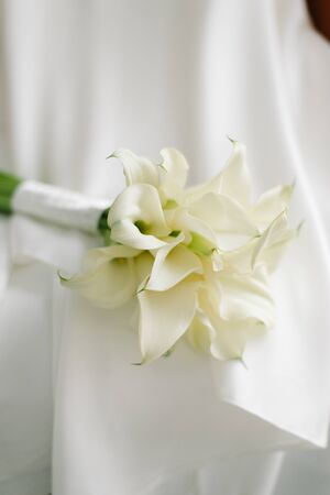 A close up wedding bouquet, white calla lilies.の写真素材