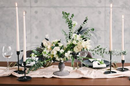 Table setting at a luxury wedding and Beautiful flowers in a vase on the table.の写真素材
