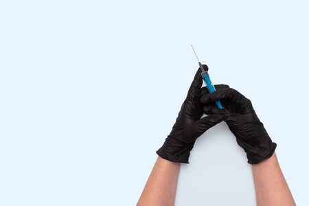 Hands in black protective gloves with a syringe. Medicine,の写真素材