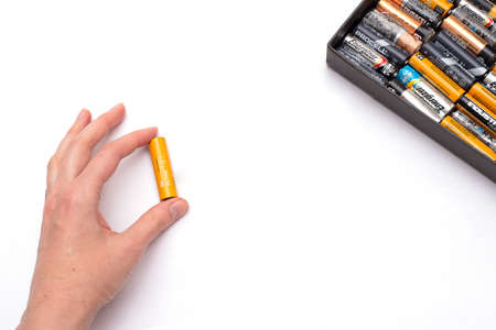 person holds Used alkaline batteries AA size format.のeditorial素材