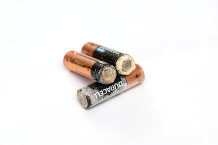 old battery leak on white isolated background. Hazardous waste concept.