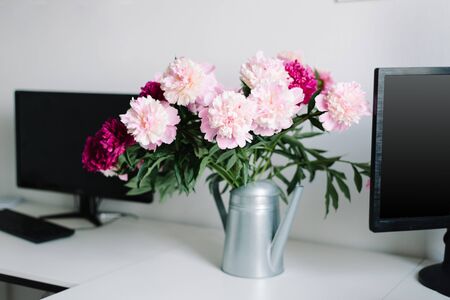 peonies in a garden watering can, a desktop in the homeの写真素材