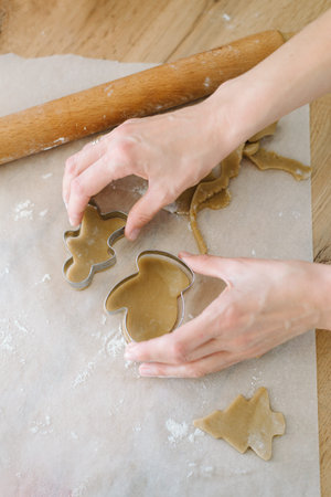 Woman preparing christmas cookies, tree shape,flour, rolling pin