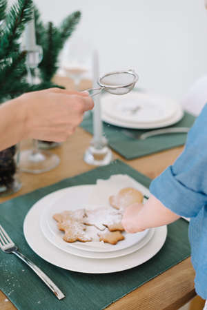 Mother and daughter preparing christmas cookies, tree shapeの写真素材