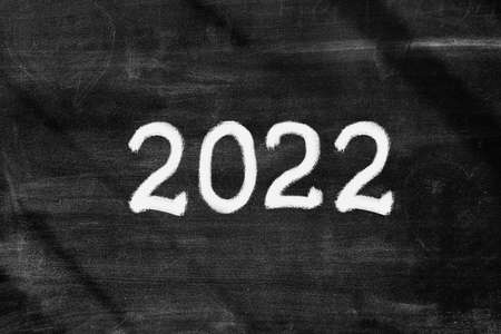 inscription 2022 on blackboard with chalk. new yearの写真素材