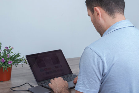 Young man, businessman working on his laptop at home. Freelance. Self-isolation. Quarantine. Home...
