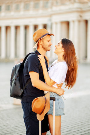 A young couple of travellers hugging in the city and enjoying romance. Lovers smiling and huggingの写真素材