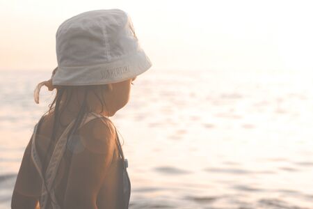 Little Girl Looking At The Sea At Sunsetの写真素材