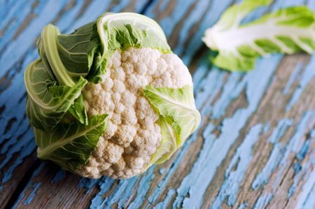 Fresh cauliflower with vegetables on a wooden table. Cabbage Bulgarian pepper chili Pumpkin Radish Healthyの写真素材