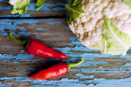 Fresh cauliflower with vegetables on a wooden table. Cabbage Bulgarian pepper chili Pumpkin Radish Healthyの写真素材