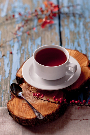 A cup of tea on a wooden background. Hot tea, white cup, vintage backgroundの写真素材