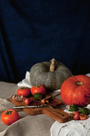 Autumn arrangement: persimmon, pumpkin, feijoa with autumn leaves. Autumn fudfoto lifestyleの写真素材