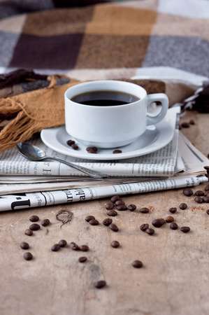A cup of coffee Black coffee hot drink Grains Newspapers Wooden background Checkered Plaid Heart Fall Autumn winter drinkの写真素材