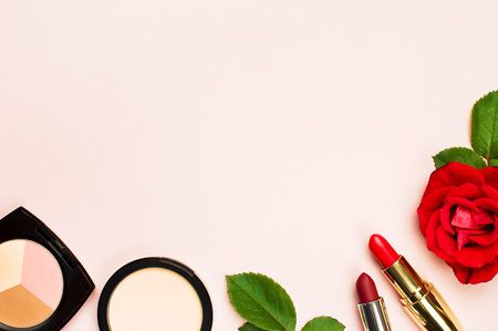 Various makeup products with red roses on a pink background with copy space top view Flat Lay. Women's thingsの写真素材