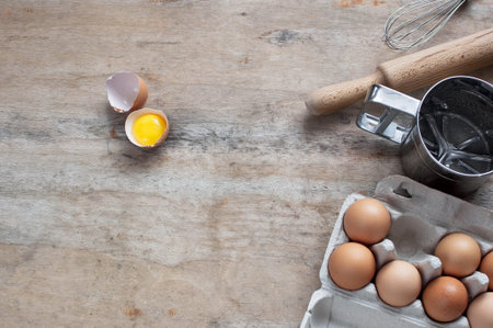 Kitchen items Metal Utensils Spoon Eggs on a wooden table. Cooking Baking Eggs Groceries Top View kitchenwareの写真素材